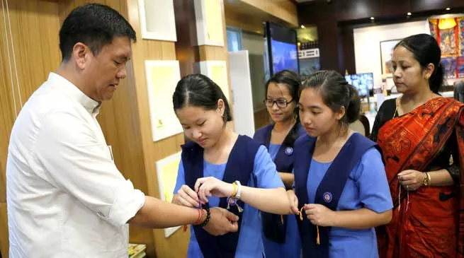 Students and members of BJP Mahila Morcha tie Rakhi to CM khandu