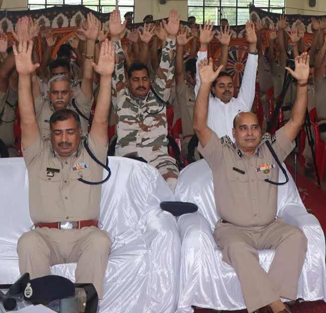 International Yoga Day- ITBP officials practicing yoga in uniform, boot and belt on waist